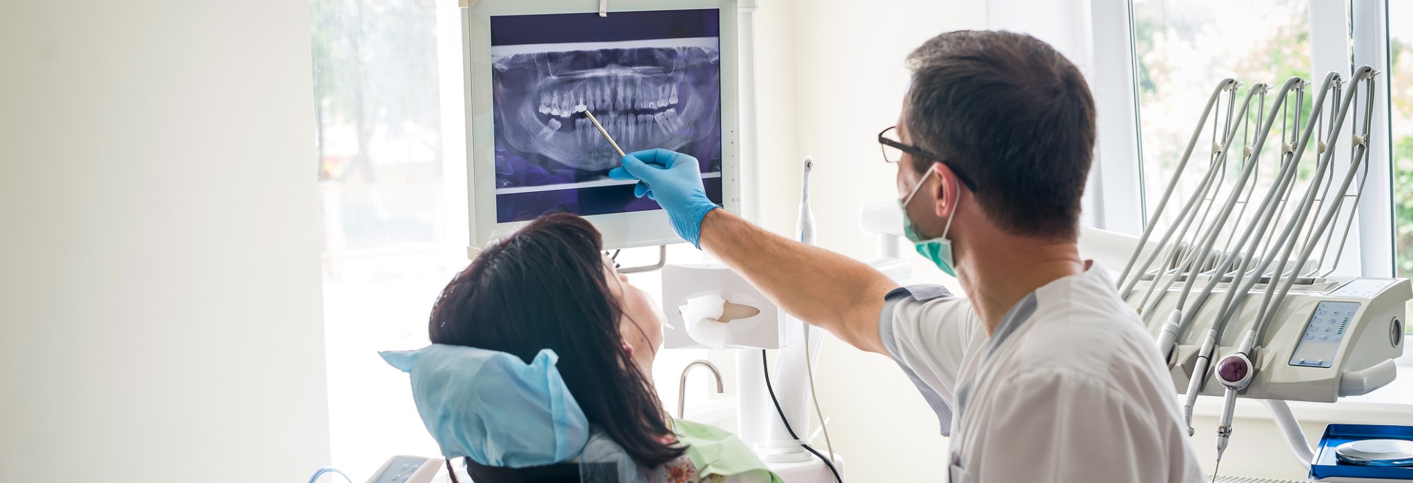 doctor-dentist-showing-patients-teeth-on-xray-picture